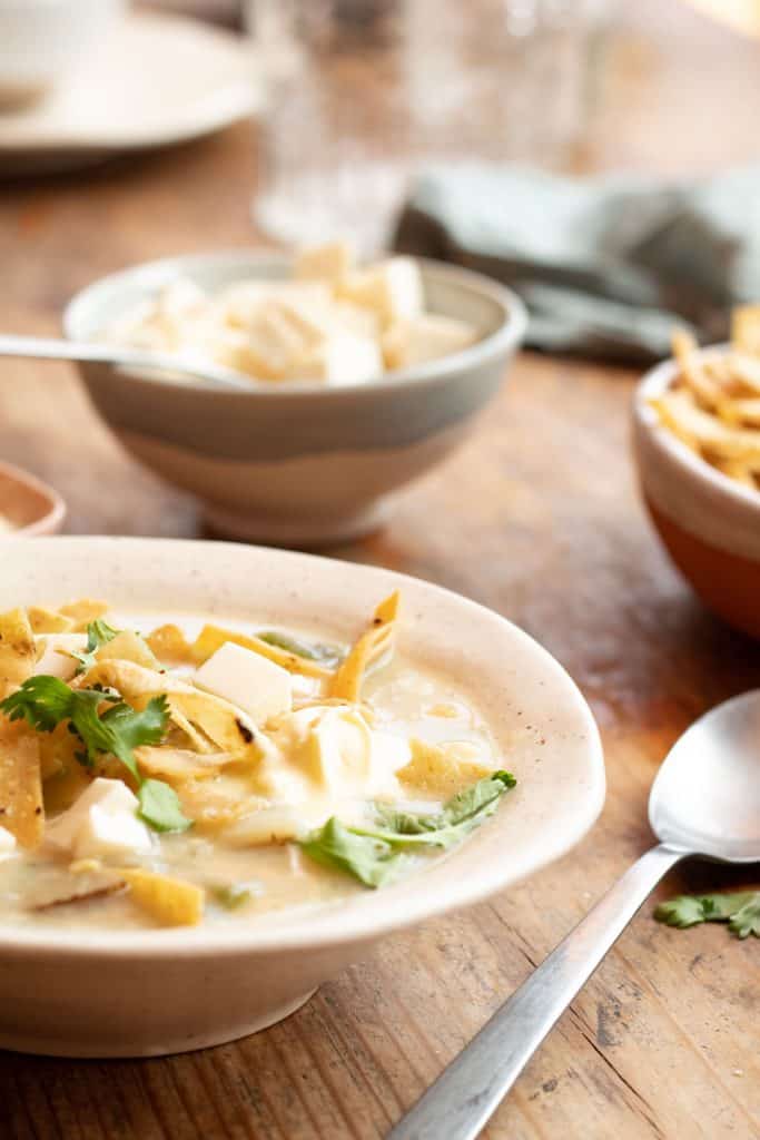 Crema de elote y poblano servida en plato hondo