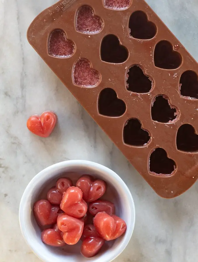 molde con gomitas de fresa y un recipiente hondo con varias gomitas